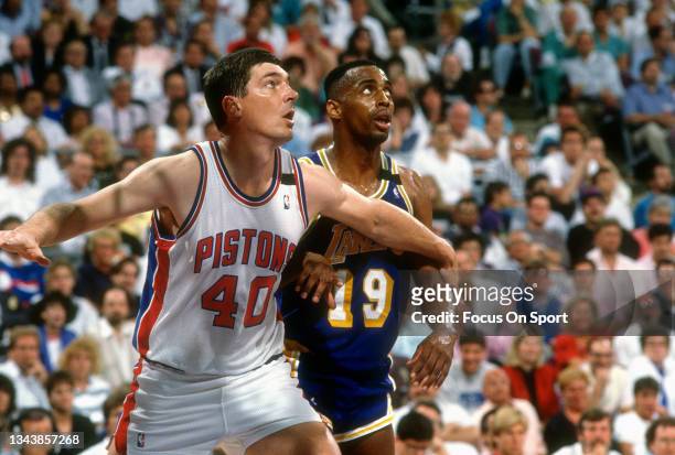 Bill Laimbeer of the Detroit Pistons works for position on Tony Campbell of the Los Angeles Lakers during an NBA basketball game circa 1989 at the...