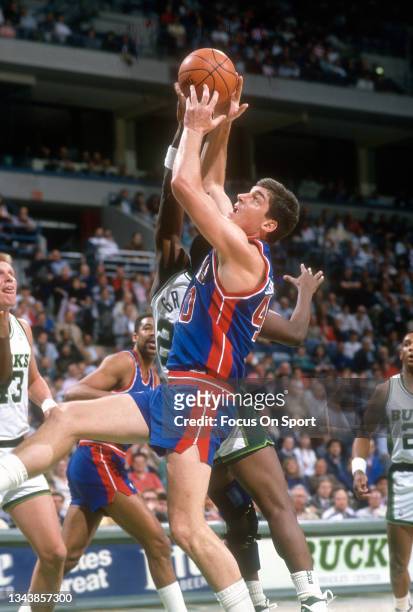 Bill Laimbeer of the Detroit Pistons fights for a rebound against the Milwaukee Bucks during an NBA basketball game circa 1992 at the Bradley Center...