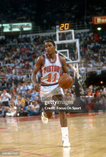 Isiah Thomas of the Detroit Pistons dribbles the ball up court during an NBA basketball game circa 1990 at The Palace of Auburn Hills in Auburn...