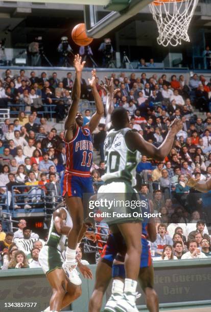 Isiah Thomas of the Detroit Pistons shoots over Jeff Grayer of the Milwaukee Bucks during an NBA basketball game circa 1990 at the Bradley Center in...