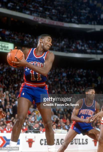 Isiah Thomas of the Detroit Pistons grabs a rebound against the Chicago Bulls during an NBA basketball game circa 1990 at Chicago Stadium in Chicago,...