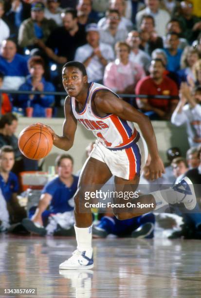 Isiah Thomas of the Detroit Pistons dribbles the ball up court against the Boston Celtics during an NBA basketball game circa 1988 at The Palace of...