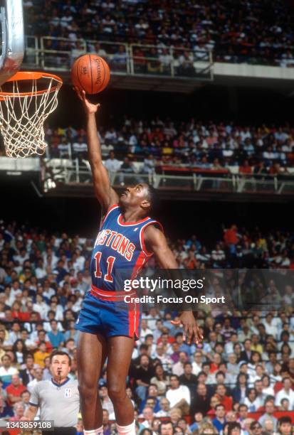 Isiah Thomas of the Detroit Pistons shoots against the Chicago Bulls during an NBA basketball game circa 1990 at Chicago Stadium in Chicago,...