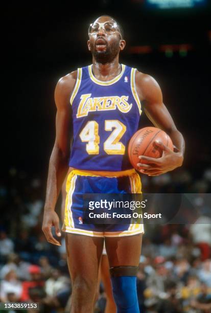James Worthy of the Los Angeles Lakers stands at the line to shoot a foul shot against the Washington Bullets during an NBA basketball game circa...