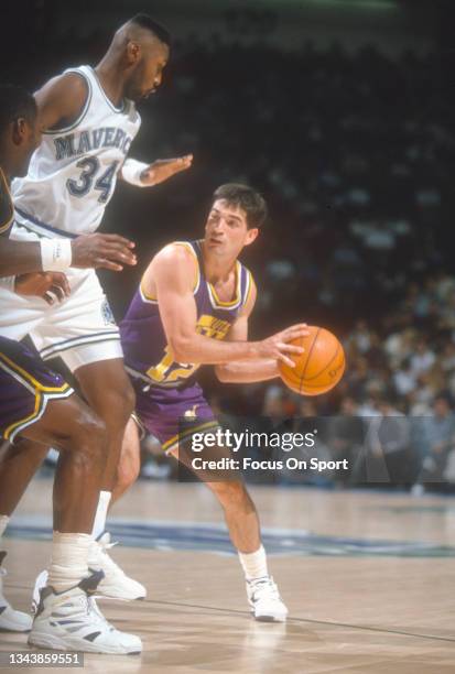 John Stockton of the Utah Jazz looks to pass the ball against the Dallas Mavericks during an NBA basketball game circa 1993 at Reunion Arena in...