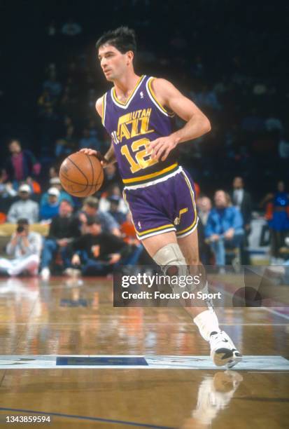John Stockton of the Utah Jazz dribbles the ball against the Washington Bullets during an NBA basketball game circa 1993 at the Capital Centre in...
