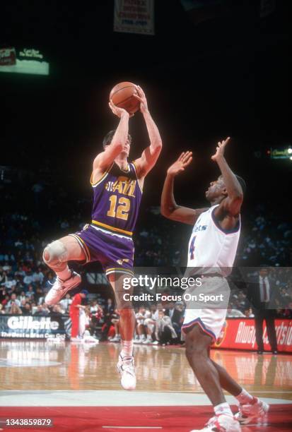 John Stockton of the Utah Jazz shoots against the Washington Bullets during an NBA basketball game circa 1993 at the Capital Centre in Landover,...