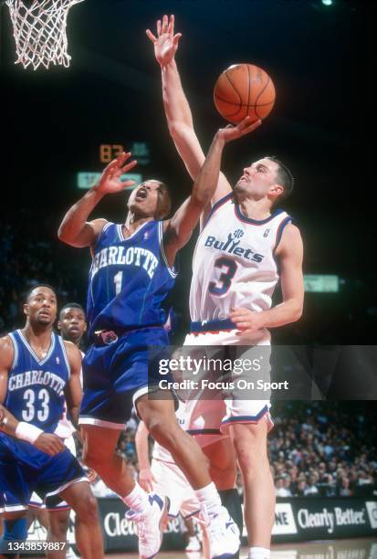 Rex Chapman of the Washington Bullets contest the shot of Muggsy Bogues of the Charlotte Hornets during an NBA basketball game circa 1995 at the US...