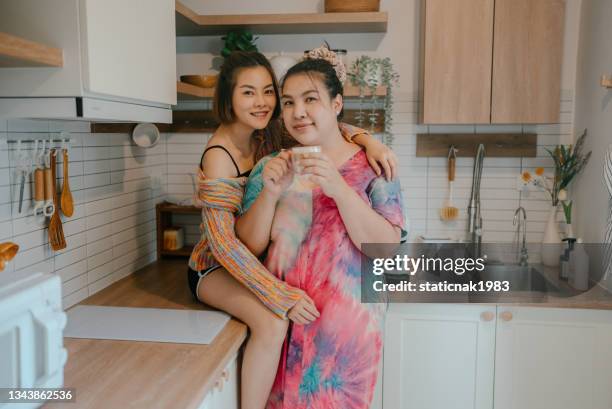 transgender female couple at home. - girlfriend stock pictures, royalty-free photos & images