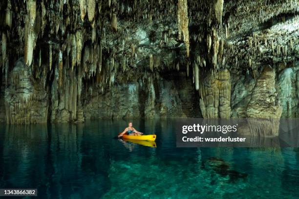 kayaking inside a cave cenote, mexico - cenote stock pictures, royalty-free photos & images