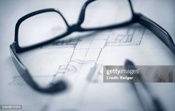 glasses and pen on top of technical drawing. - rights bildbanksfoton och bilder