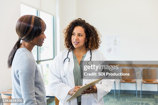 Senior female patient and mid adult doctor discuss test results Senior female patient and mid adult doctor discuss test results