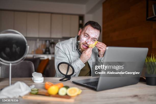 funny male making mess while trying to follow skin care procedure - staring stock pictures, royalty-free photos & images