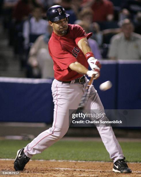 Boston Red Sox infielder Mike Lowell hits a base hit in a spring training game against the New York Yankees Wednesday March 22, 2006 at Legends Field...