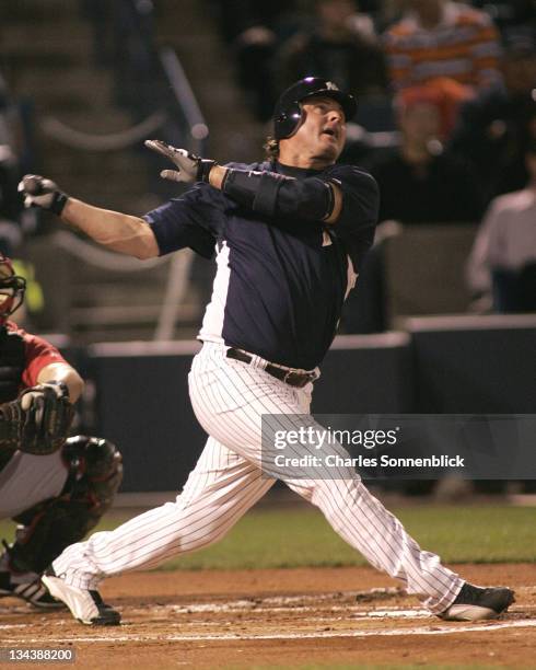 Yankees DH Jason Giambi watches the ball after hitting it in a spring training game against the Reds on March 7, 2007 at Legends Field in Tampa,...