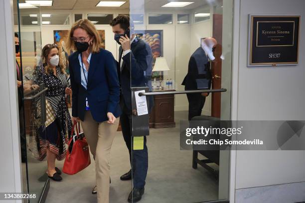 White House Legislative Affairs Director Louisa Terrell and National Economic Council Director Brian Deese leave a meeting with Sen. Kyrsten Sinema...