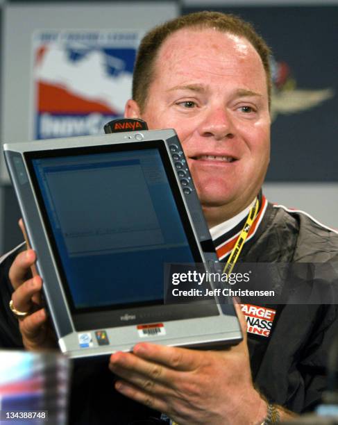 Chip Ganassi, owner of the Target Chip Ganassi Racing team, holds a Tablet PC powered by Microsoft Windows XP Tablet Edition during a news conference...