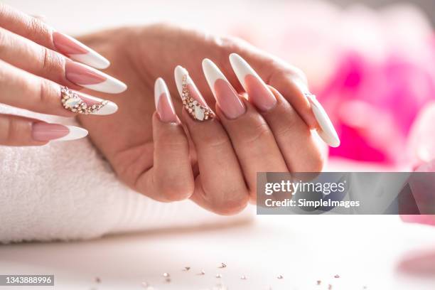 perfectly prepared gel nails decorated with diamonds. - manicure fotografías e imágenes de stock