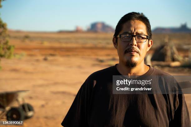 native american navajo man in his twenties with a tracheotomy scar at the front of his neck due to being put on a ventilator because he had covid-19 coronavirus - indian man stockfoto's en -beelden