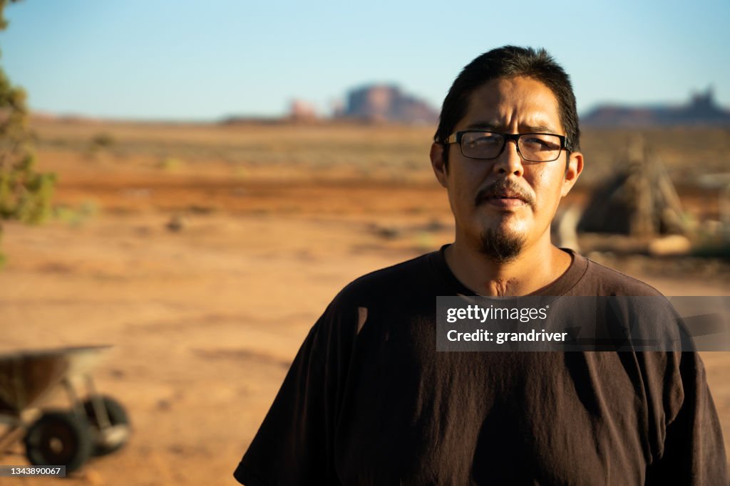 Native American Navajo man in his twenties with a Tracheotomy scar at the front of his neck due to being put on a ventilator because he had Covid-19 Coronavirus