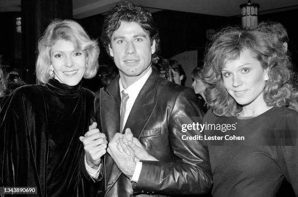 American actor and singer John Travolta poses for a portrait with a friend and his girlfriend American actress, producer, radio host, singer,...