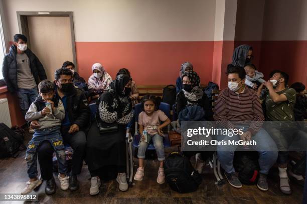 Newly arrived refugees from Afghanistan are seen waiting to be processed by Turkish officials at the Kurubas migrant repatriation center during a...