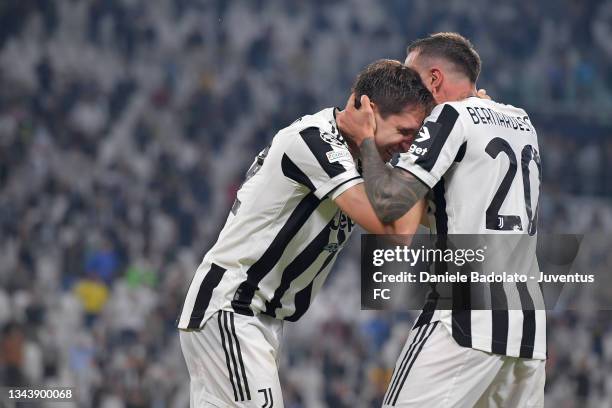 Federico Chiesa of Juventus celebrates after scoring his team's first goal with teammate Federico Bernardeschi during the UEFA Champions League group...