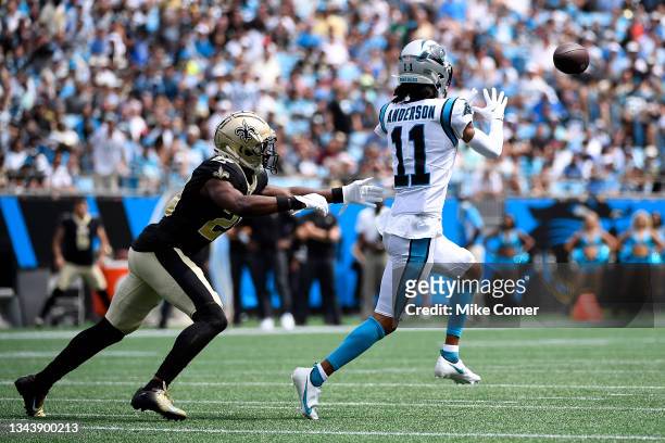 Wide receiver Robby Anderson of the Carolina Panthers makes a reception over cornerback Paulson Adebo of the New Orleans Saints for a first down...