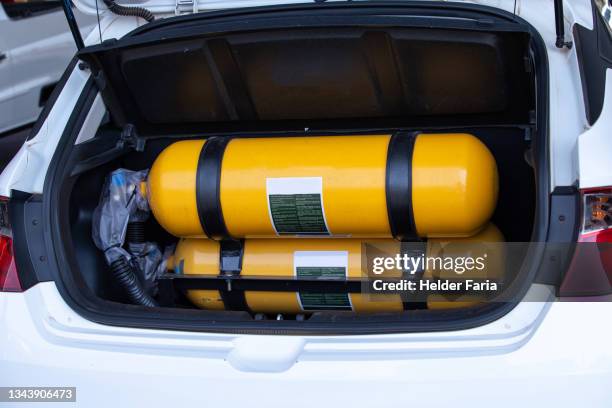 natural gas reservoir tank in car trunk - cng stock-fotos und bilder