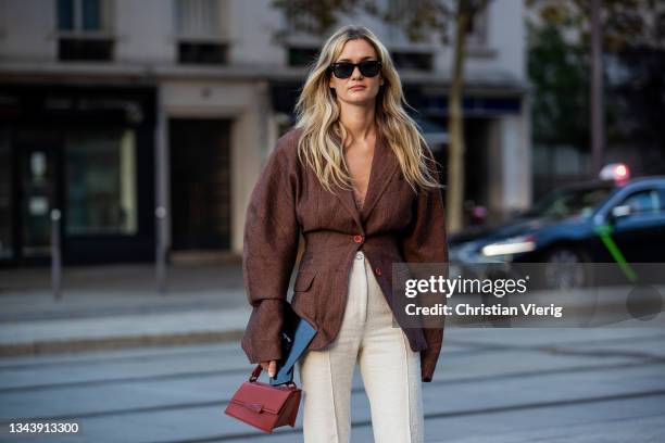 Anne-Laure Mais is seen wearing brown blazer, creme white pants, bag outside Acne during Paris Fashion Week - Womenswear Spring Summer 2022 on...