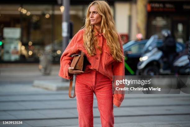 Blanca Miro Scrimieri seen wearing red pants and jacket, brown bag outside Acne during Paris Fashion Week - Womenswear Spring Summer 2022 on...