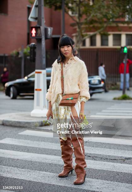 Susie Lau seen wearing brown bag, boots, dress, knitted jumper outside Acne during Paris Fashion Week - Womenswear Spring Summer 2022 on September...