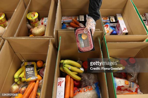Boxes of food are prepared before the BBM foodbank opens it's drive-through service at a nearby church carpark on September 30, 2021 in Auckland, New...