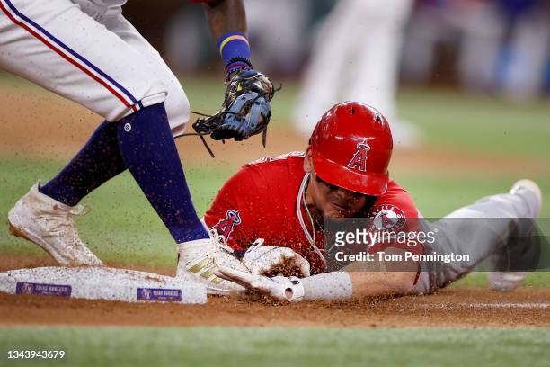 Juan Lagares of the Los Angeles Angels is tagged out by Yonny Hernandez of the Texas Rangers on a pick off throw from Jose Trevino of the Texas...