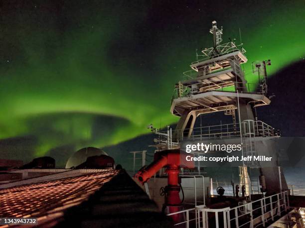 the aurora australis floats behind the superstructure of a ship, southern ocean, antarctica. - aurora australis bildbanksfoton och bilder