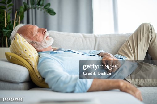 Senior man having a good nap at home.