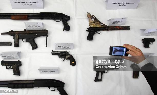 Journalists takes a photo of weapons Weapons found by police at the former residence as well as at a camper of neo-Nazis Uwe Mondlos and Uwe...