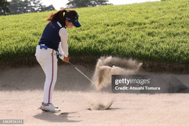 Serena Aoki of Japan hits out from a bunker on the 13th hole during the first round of the 54th Japan Women's Open Golf Championship at Karasuyamajo...
