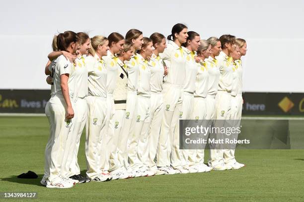 Players of Australia stand together for the national anthems during day one of the Women's International Test match between Australia and India at...