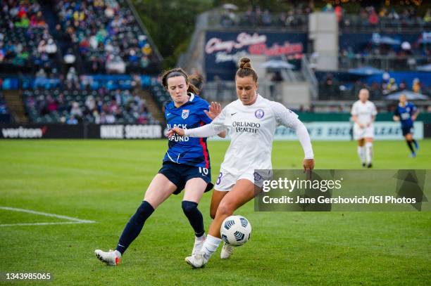 Rose Lavelle of the OL Reign and Meggie Dougherty Howard of the Orlando Pride battle for the ball during a game between Orlando Pride and OL Reign at...