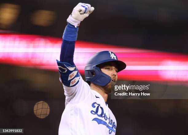 Cody Bellinger of the Los Angeles Dodgers celebrates a solo homerun, to tie the San Diego Padres 9-9, during the eighth inning at Dodger Stadium on...