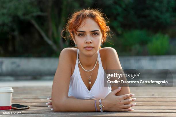 mixed race woman relaxing after exercising - camisa sin mangas fotografías e imágenes de stock