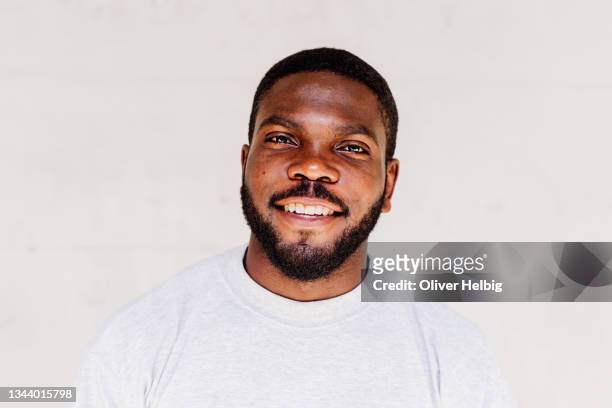 portrait of delighted african american male with positive smile, looks happily at camera, being successful - charmig bildbanksfoton och bilder