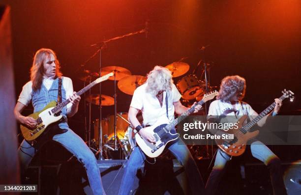 Francis Rossi, Rick Parfitt and Alan Lancaster of Status Quo perform on stage at Hammersmith Odeon on March 14th, 1981 in London, United Kingdom.