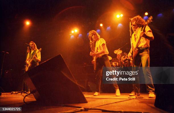 Francis Rossi, Rick Parfitt and Alan Lancaster of Status Quo perform on stage at Hammersmith Odeon on March 14th, 1981 in London, United Kingdom.