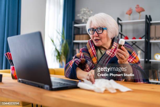 senior  woman speaking with his doctor online about prescription medication - medicare supplement stock pictures, royalty-free photos & images