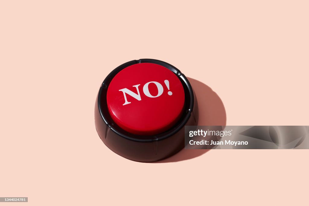 Red push button with the word no