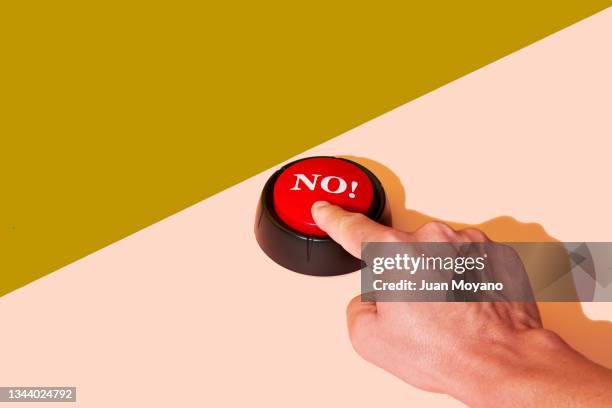 man pushing a red button with the word no - pushing fotografías e imágenes de stock