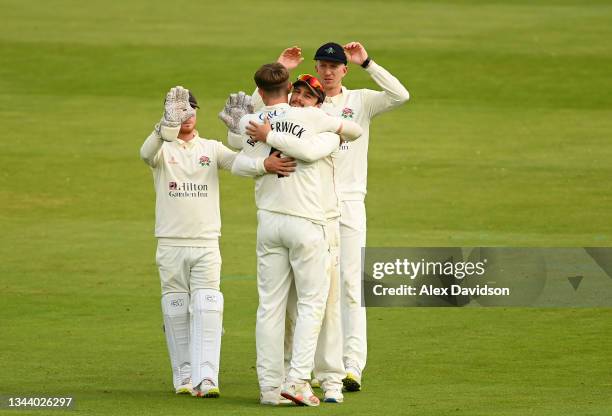 Jack Blatherwick of Lancashire celebrates with Rob Jones after taking the wicket of Will Rhodes of Warwickshire during Day 3 of the Bob Willis Trophy...