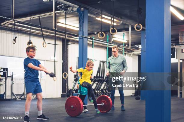 boys exercising with male instructor in gym - cross training stock pictures, royalty-free photos & images